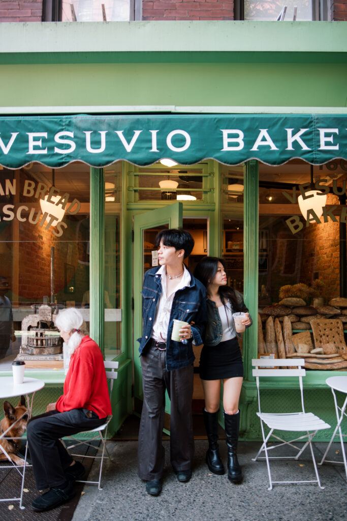 Couple sitting outside of a bakery in Soho 