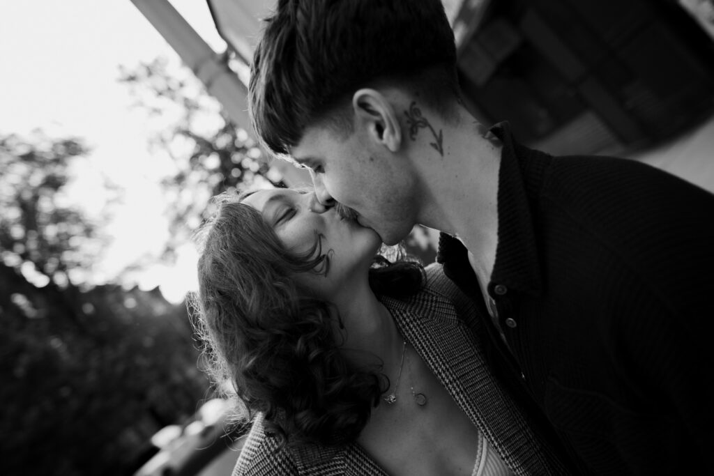 Black and white image of couple kissing at the end of their engagement session in Brooklyn, New York 