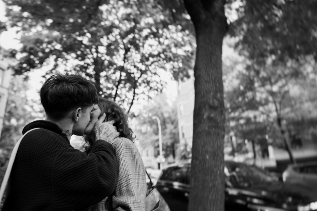 Black and white image of couple kissing on the streets of Park Slope during their engagement session in Brooklyn