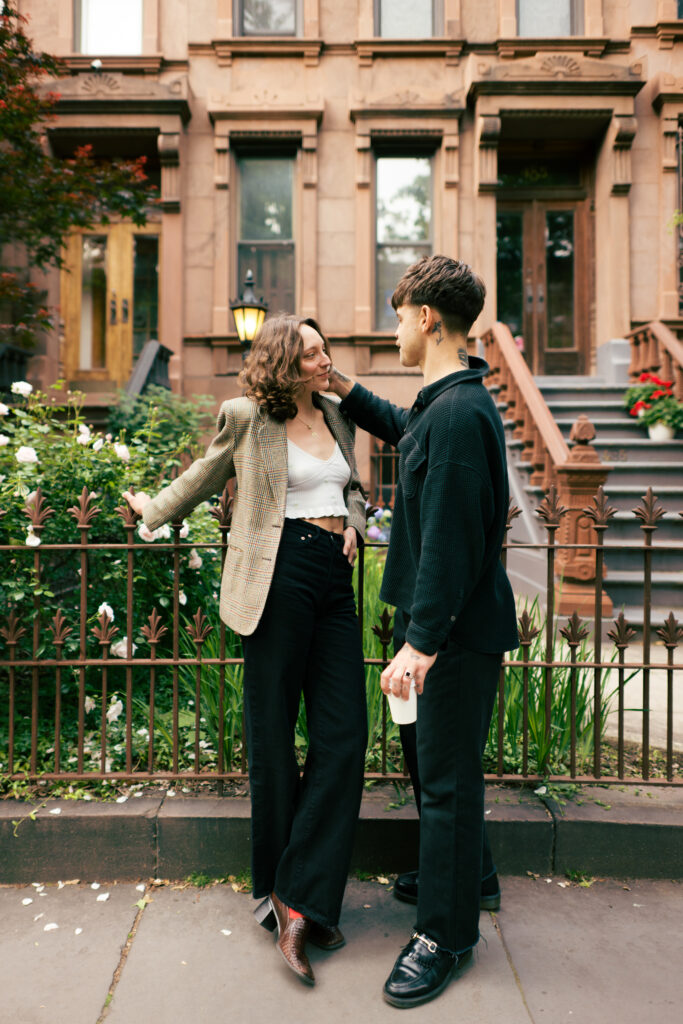 Groom brushing the hair behind his brides ear during their engagement session in Brooklyn