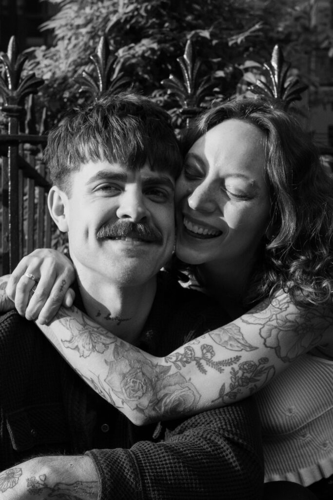 Up close black and white image of couple smooshing their faces together during their Brooklyn engagement session 