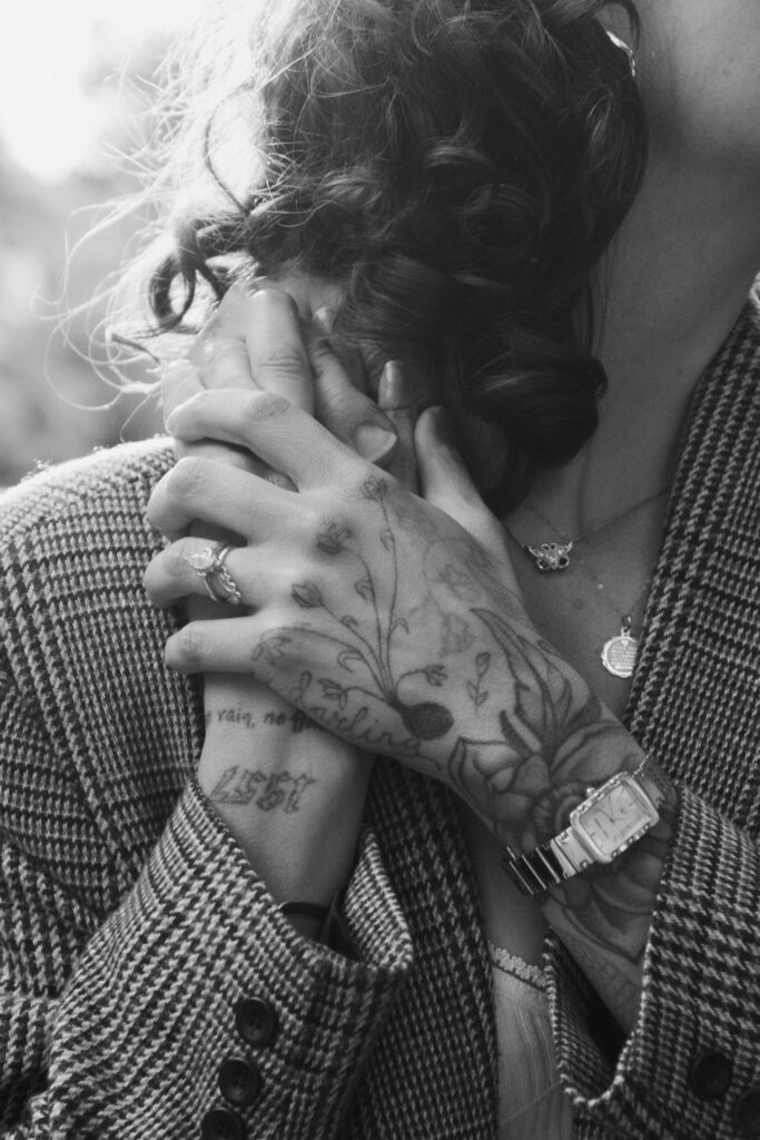 Black and white detail photo of brides wedding bands during their engagement session in Brooklyn