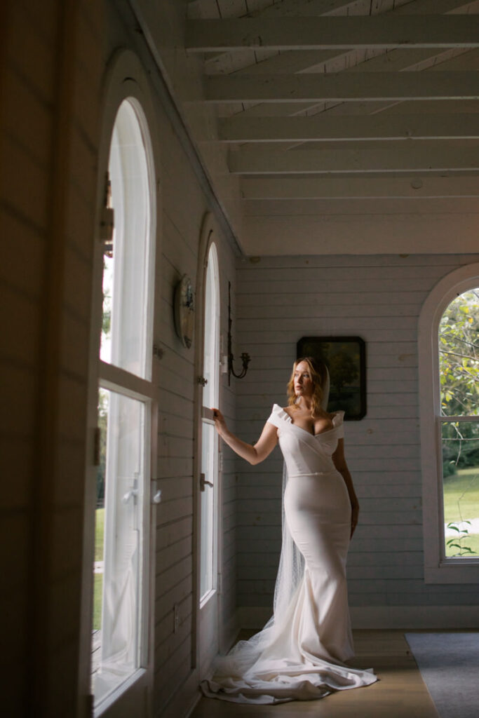 Editorial Wedding Photography of bride posing looking out the window