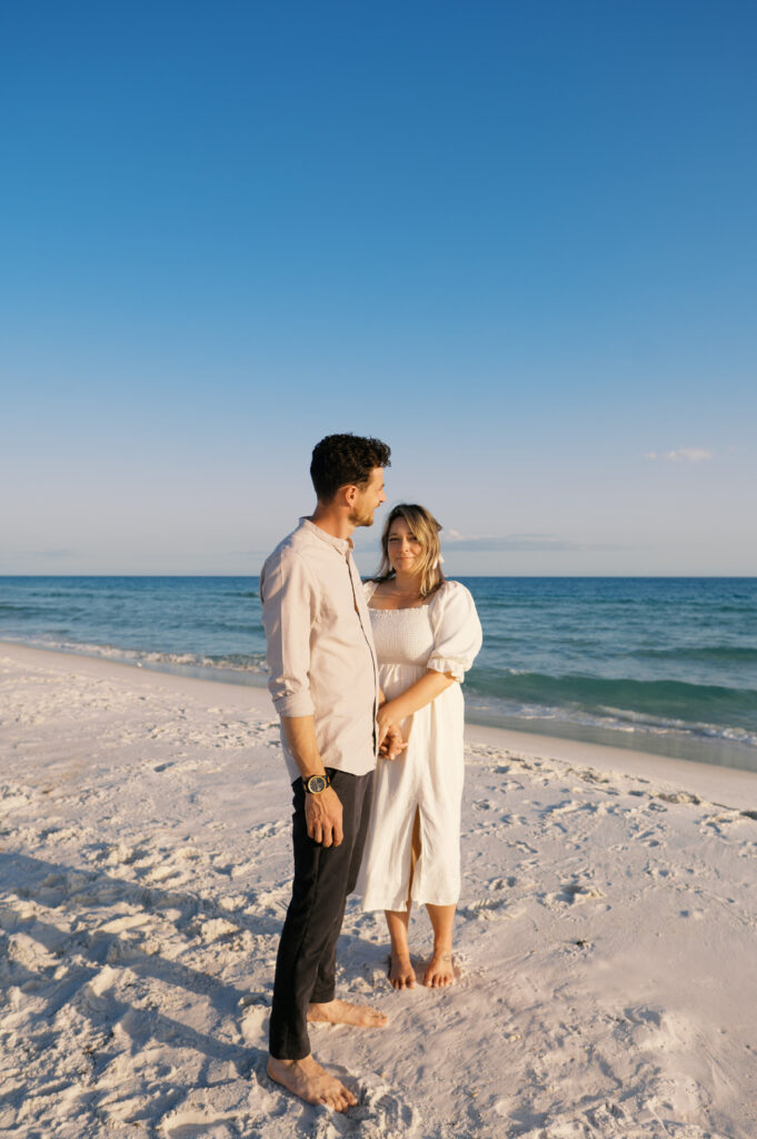 A couple posing on the beach on the coast in Wilmington, North Carolina