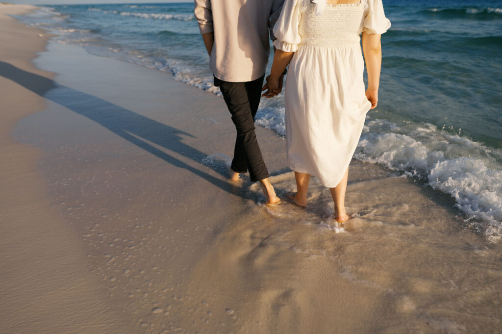 A couple walking on the beach on the coast in Wilmington, North Carolina