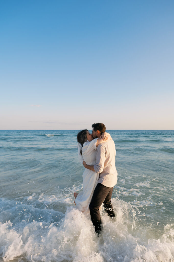 A couple kissing in the ocean on the coast in Wilmington, North Carolina